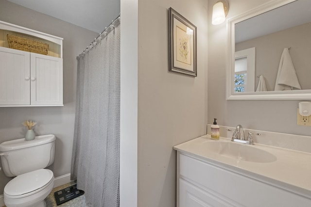 bathroom featuring toilet, vanity, and curtained shower
