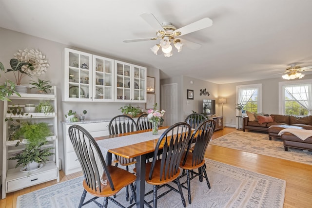 dining space featuring ceiling fan and light wood-style floors