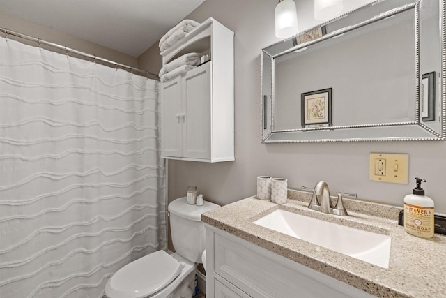 bathroom with vanity, toilet, and curtained shower