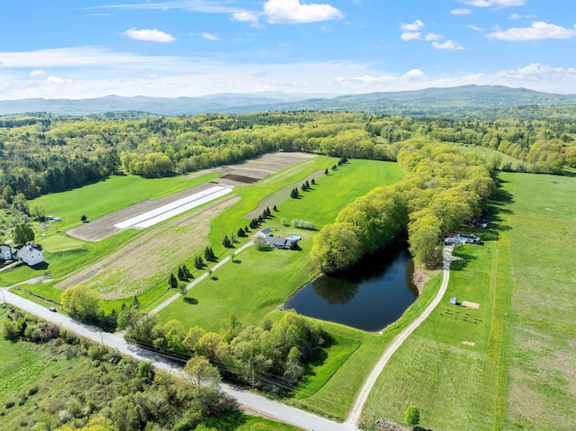 view of rural area featuring a water and mountain view and a heavily wooded area