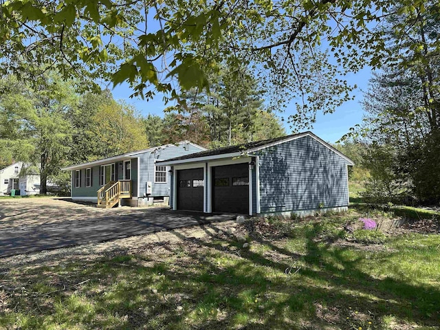 view of front of house with an attached garage and asphalt driveway