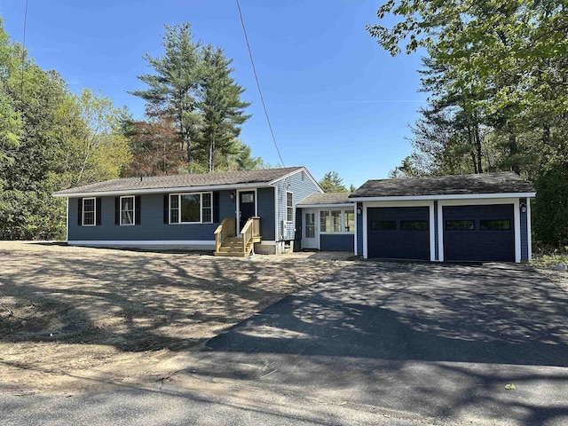 view of front of home featuring a garage and asphalt driveway