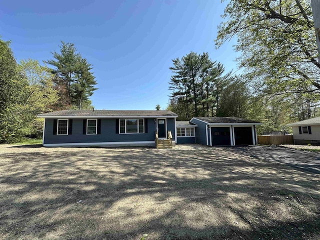 view of front of property featuring fence, entry steps, and an attached garage