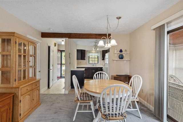 dining space featuring light carpet, a chandelier, and baseboards