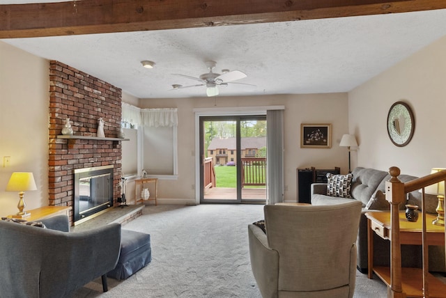 carpeted living area featuring a brick fireplace, a ceiling fan, a textured ceiling, and baseboards