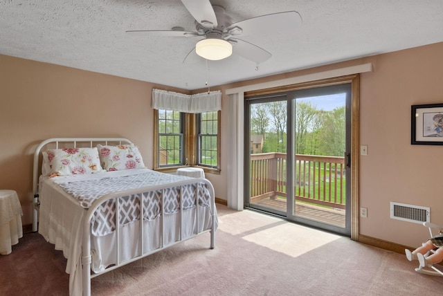 bedroom with carpet, access to exterior, baseboards, and ceiling fan