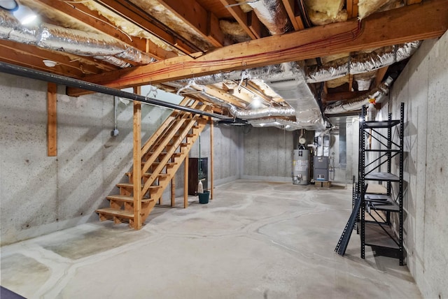 unfinished below grade area featuring gas water heater, stairs, and heating unit