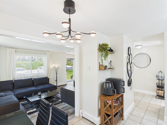 8 Lincoln Dr Unit B, Hooksett, NH 03106 - living room featuring a baseboard radiator, light tile patterned flooring, a chandelier, and baseboards
