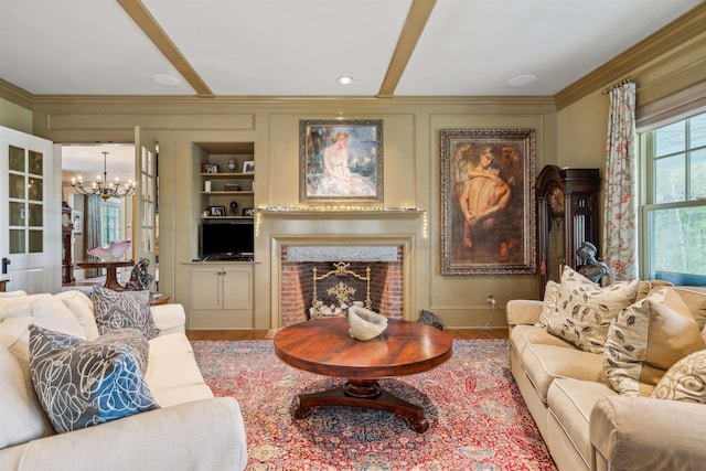 5893 Stage Rd, Barnard, VT 05031 - living area with a chandelier, wood finished floors, crown molding, a brick fireplace, and built in shelves
