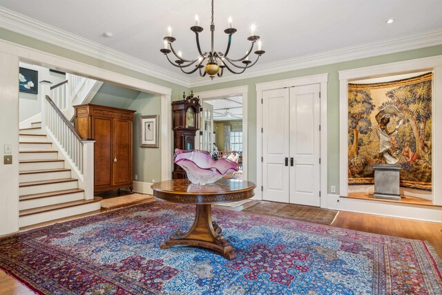 5893 Stage Rd, Barnard, VT 05031 - foyer entrance with a chandelier, stairway, wood finished floors, crown molding, and baseboards