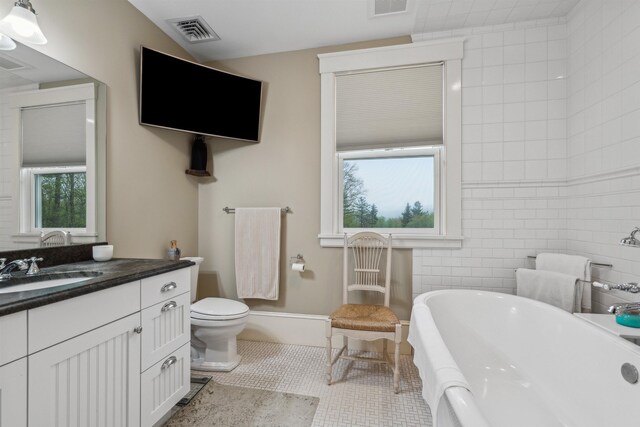 5893 Stage Rd, Barnard, VT 05031 - full bath featuring a soaking tub, tile patterned flooring, healthy amount of natural light, and toilet