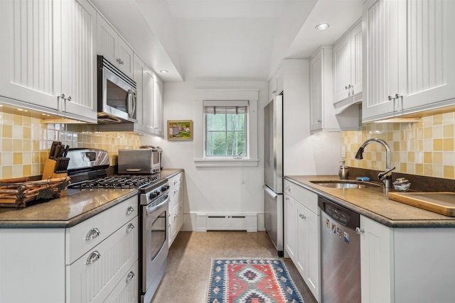 5893 Stage Rd, Barnard, VT 05031 - kitchen featuring stainless steel appliances, a sink, a baseboard radiator, white cabinetry, and decorative backsplash