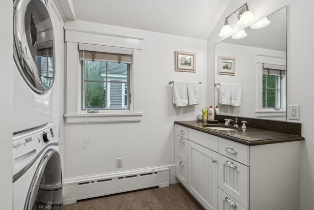 5893 Stage Rd, Barnard, VT 05031 - bathroom featuring a baseboard heating unit, estacked washer and dryer, vanity, and healthy amount of natural light