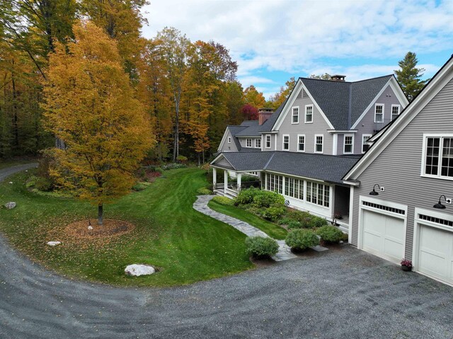 5893 Stage Rd, Barnard, VT 05031 - view of front facade with a shingled roof, a chimney, a front lawn, asphalt driveway, and covered porch