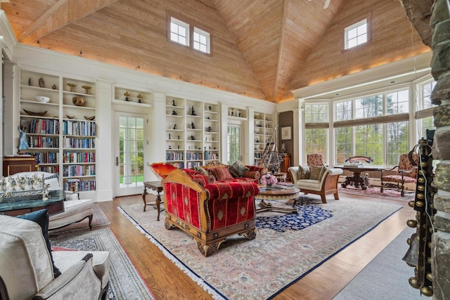 5893 Stage Rd, Barnard, VT 05031 - living area with high vaulted ceiling, wooden ceiling, healthy amount of natural light, built in shelves, and wood finished floors
