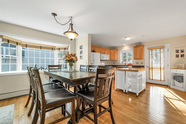 dining area with light wood-style floors