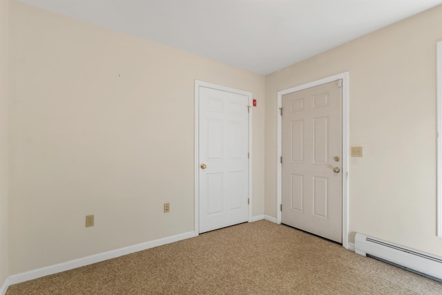 unfurnished room with a baseboard radiator, light colored carpet, and baseboards