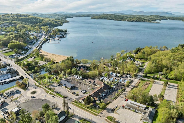 aerial view of property and surrounding area featuring a water and mountain view