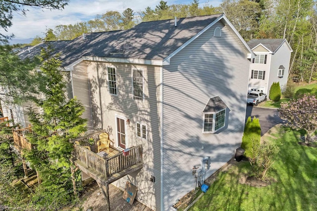 view of property exterior with a deck