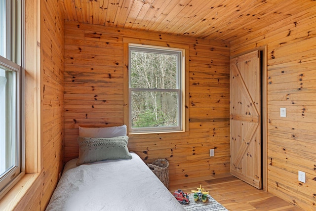 121 Ridge Ln, Westmore, VT 05860 - bedroom with wooden walls, light wood finished floors, and wooden ceiling