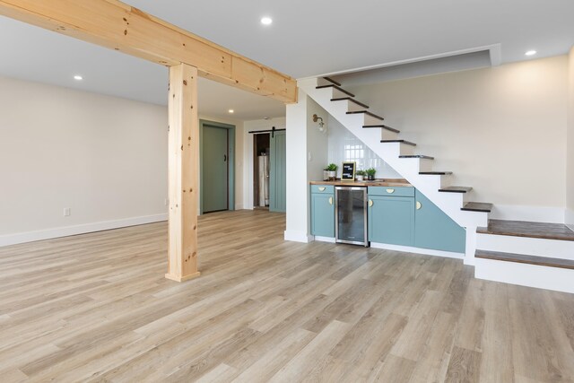 121 Ridge Ln, Westmore, VT 05860 - below grade area featuring beverage cooler, stairs, a dry bar, light wood-style floors, and baseboards