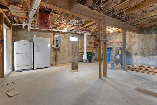 121 Ridge Ln, Westmore, VT 05860 - basement with a heating unit, a water pressure tank, electric water heater, freestanding refrigerator, and electric panel