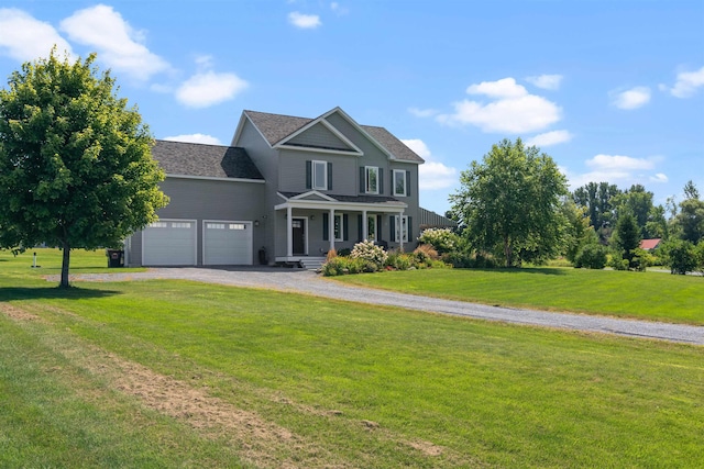view of front of home featuring a garage, driveway, a front lawn, and a porch