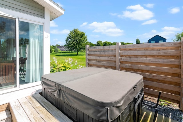 deck featuring a covered hot tub