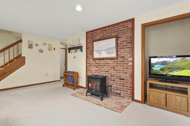 carpeted living area with a wood stove, stairs, and baseboards