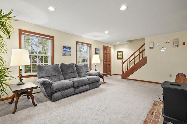 carpeted living area with recessed lighting, stairs, and baseboards