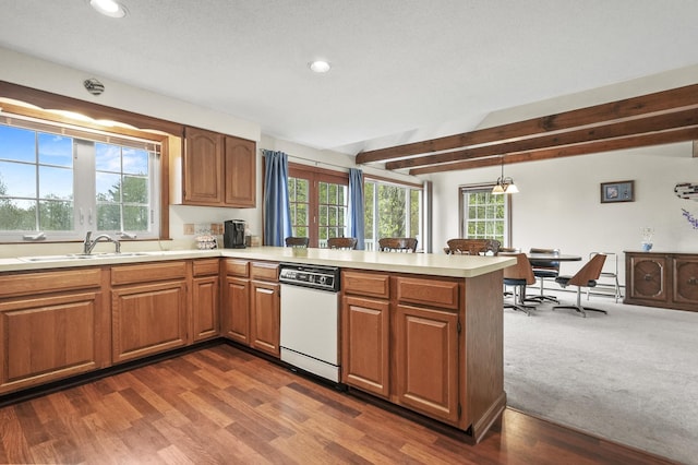 kitchen featuring a sink, recessed lighting, a peninsula, light countertops, and white dishwasher