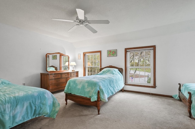 bedroom featuring carpet, ceiling fan, baseboards, and a textured ceiling