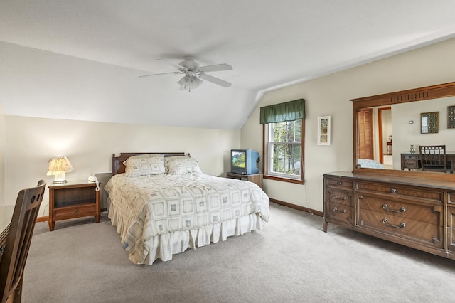carpeted bedroom featuring vaulted ceiling, baseboards, and ceiling fan