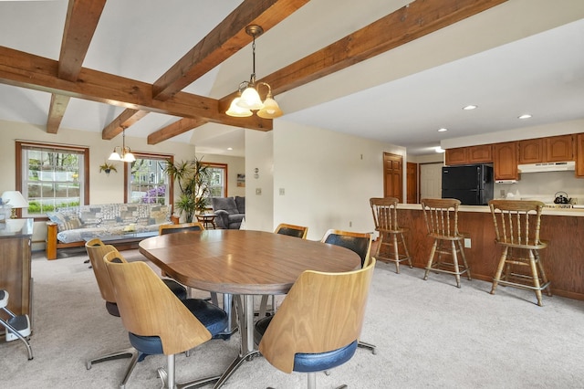 dining area with light colored carpet, beam ceiling, and recessed lighting