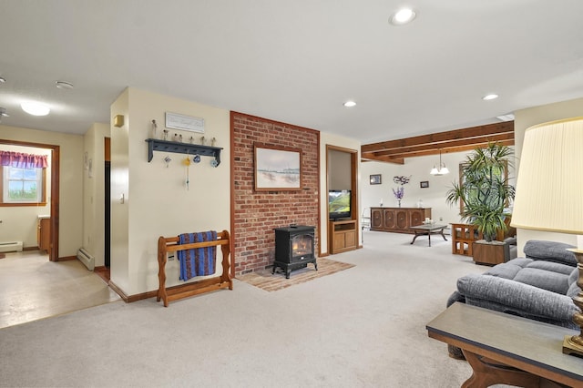living area with a baseboard heating unit, light colored carpet, a wood stove, and recessed lighting