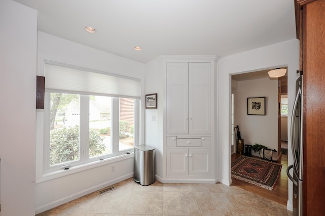 203 Straw Hill Rd, Manchester, NH 03104 - bedroom with multiple windows, freestanding refrigerator, baseboards, and light tile patterned floors