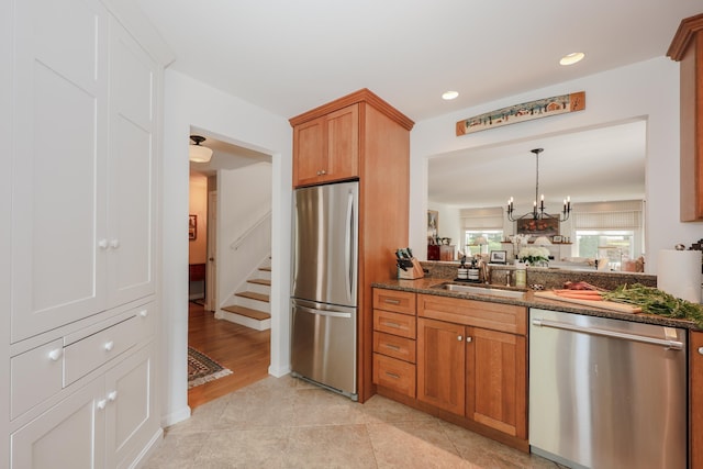 203 Straw Hill Rd, Manchester, NH 03104 - kitchen with stainless steel appliances, dark stone countertops, a chandelier, a sink, and recessed lighting