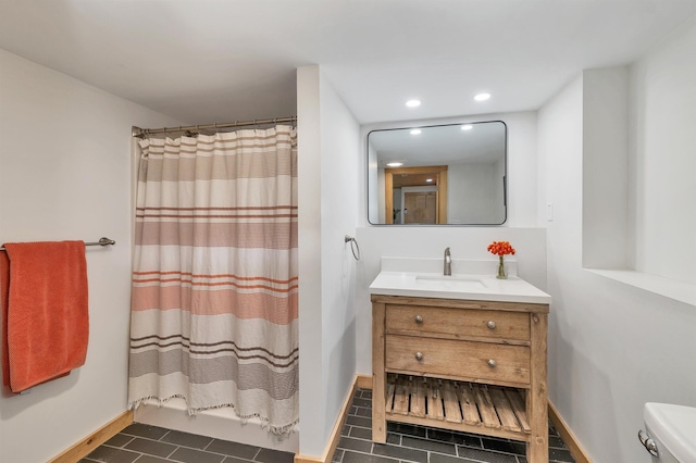 bathroom featuring baseboards, tile patterned flooring, recessed lighting, vanity, and toilet