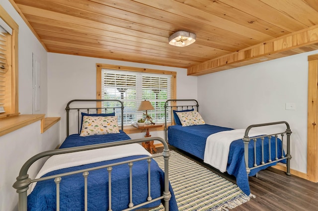 bedroom featuring wood finished floors, wood ceiling, and baseboards