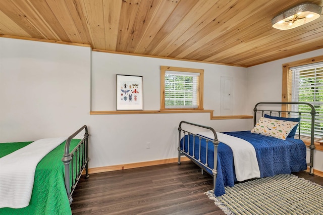 bedroom featuring wooden ceiling, multiple windows, wood finished floors, baseboards, and ornamental molding