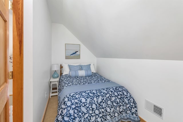 bedroom featuring lofted ceiling and carpet floors