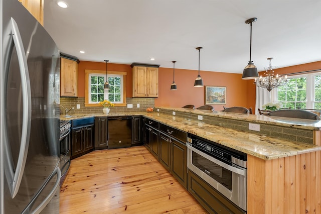 kitchen featuring stainless steel appliances, light wood-type flooring, plenty of natural light, a peninsula, and recessed lighting