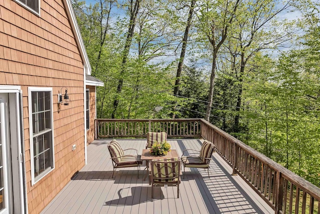 wooden terrace with view of scattered trees