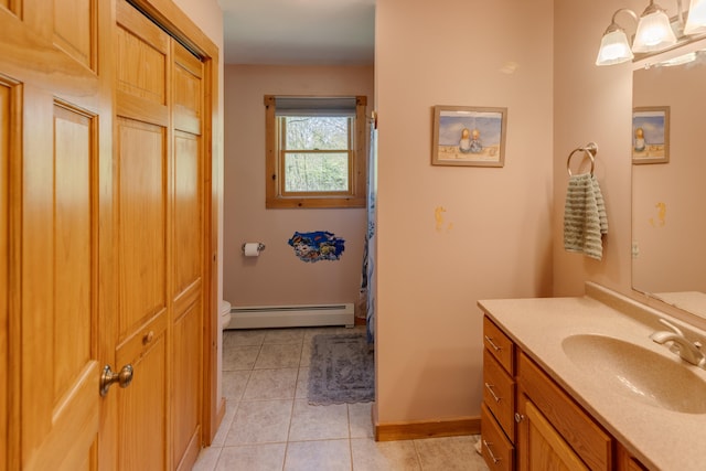 273 Berkshire Rd, Lisbon, NH 03585 - full bath with a baseboard radiator, toilet, vanity, tile patterned floors, and baseboards