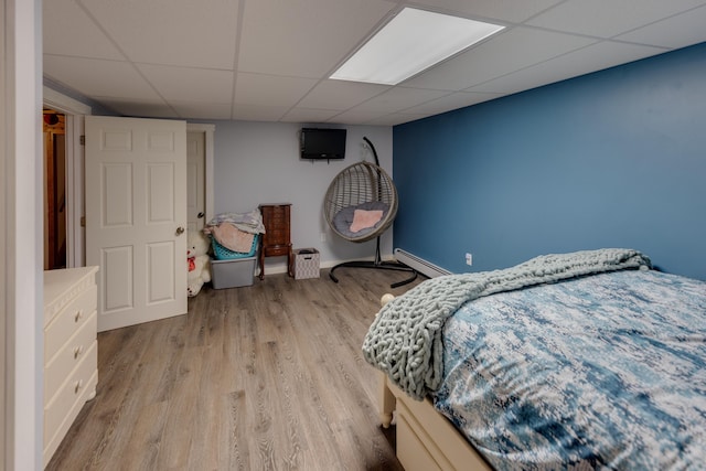 273 Berkshire Rd, Lisbon, NH 03585 - bedroom featuring a baseboard radiator, a drop ceiling, and light wood-style flooring