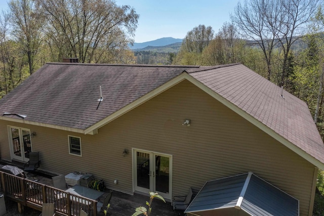273 Berkshire Rd, Lisbon, NH 03585 - rear view of property featuring french doors, roof with shingles, a mountain view, and outdoor dining area