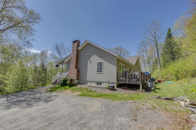 273 Berkshire Rd, Lisbon, NH 03585 - view of side of home featuring a chimney and a deck