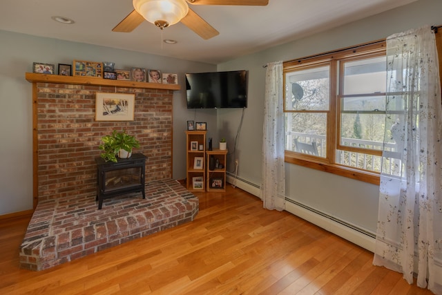 273 Berkshire Rd, Lisbon, NH 03585 - living area featuring a wood stove, light wood finished floors, and a ceiling fan