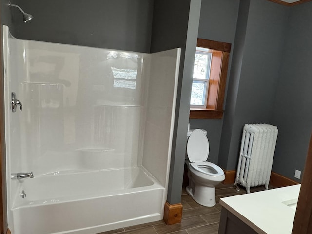 76 Center St, Richford, VT 05476 - bathroom with radiator heating unit, vanity, wood tiled floors, and shower / bathtub combination