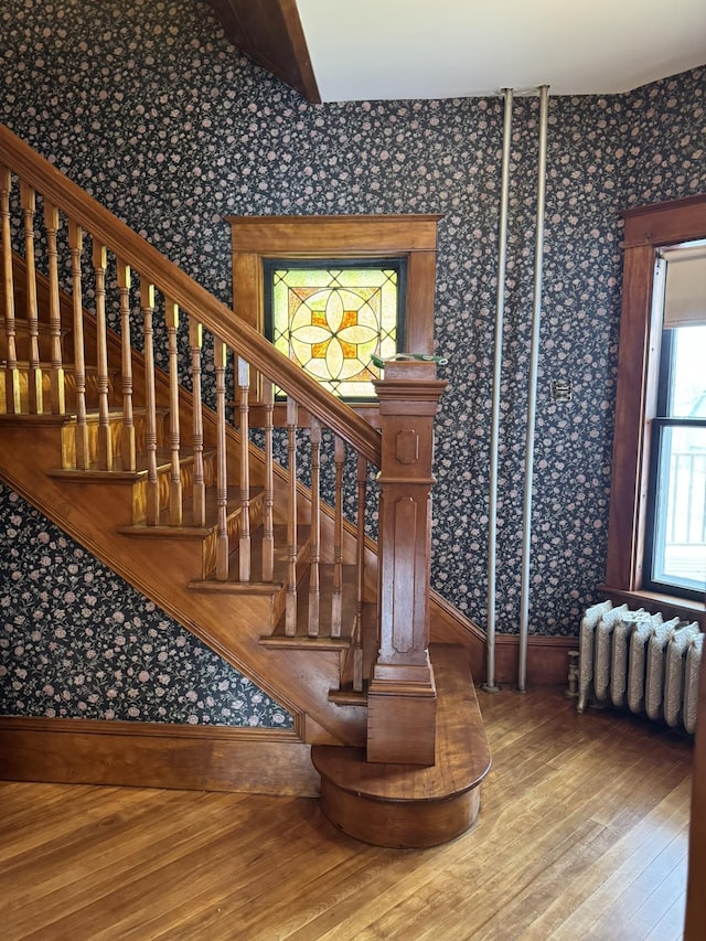 76 Center St, Richford, VT 05476 - stairs with wallpapered walls, wood-type flooring, and radiator heating unit